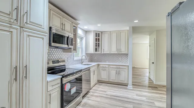 a kitchen with stainless steel appliances granite countertop a stove and a sink