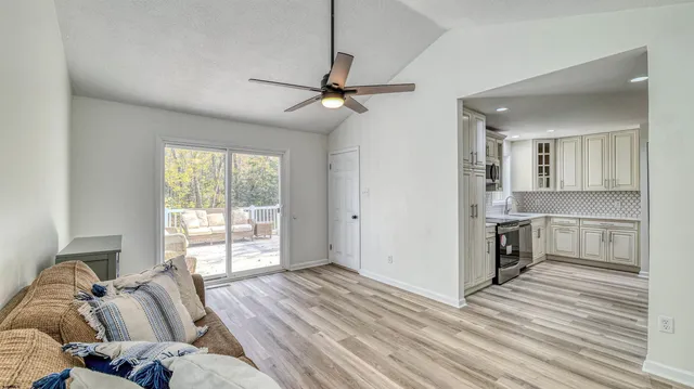 a living room with furniture and a wooden floor