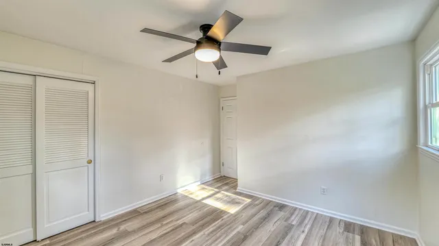 a view of room with a ceiling fan and window