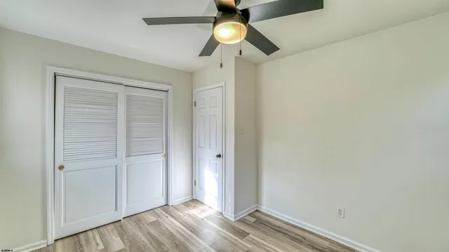 an empty room with closet and window