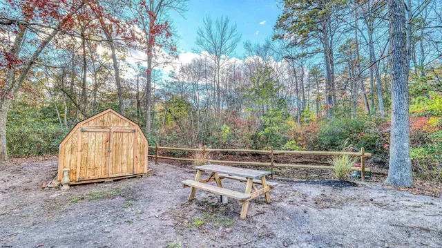 a backyard of a house with table and chairs