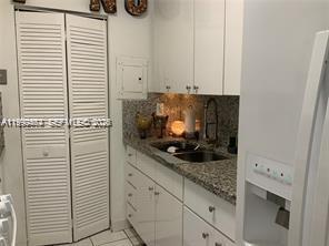 1300 West 53rd Street, Unit 19 Hialeah, FL 33012 - Photo 7 of 7 a kitchen with a white cabinets and a stove