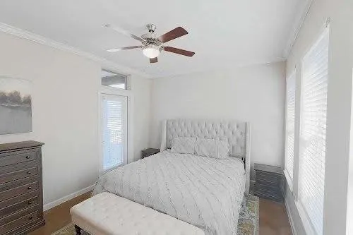 a bedroom with a large bed and a chandelier