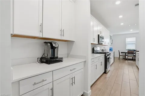 a kitchen with cabinets and appliances