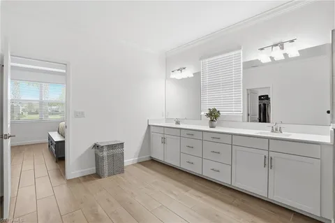 a spacious bathroom with a double vanity sink a mirror and a shower