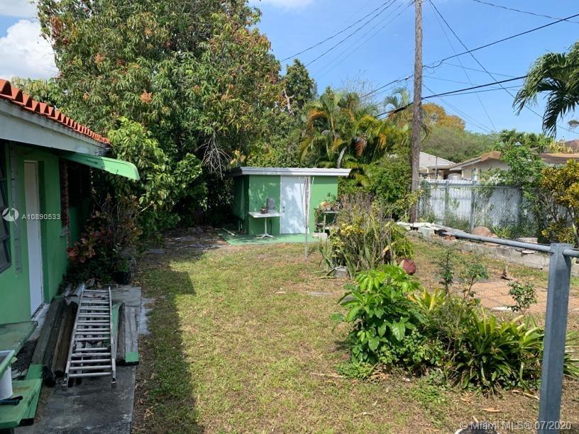 701 Tamiami Canal Road Miami, FL 33144 - Photo 11 of 13 a view of house with garden space and trees