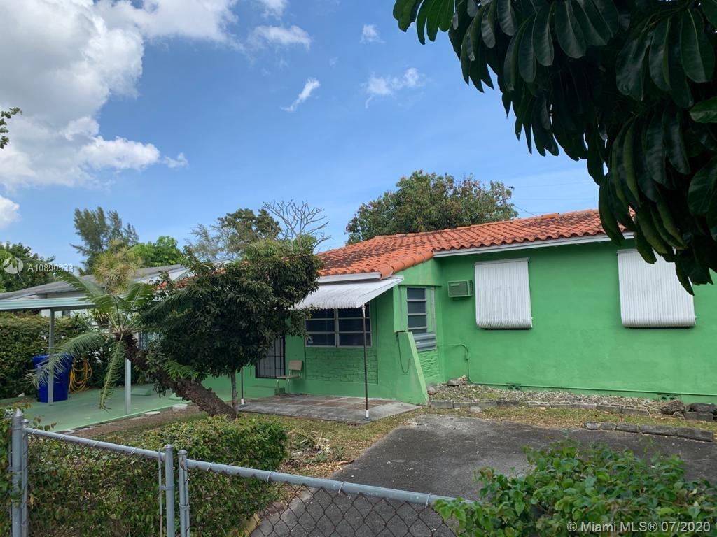 701 Tamiami Canal Road Miami, FL 33144 - Photo 13 of 13 a front view of a house with a yard and garage
