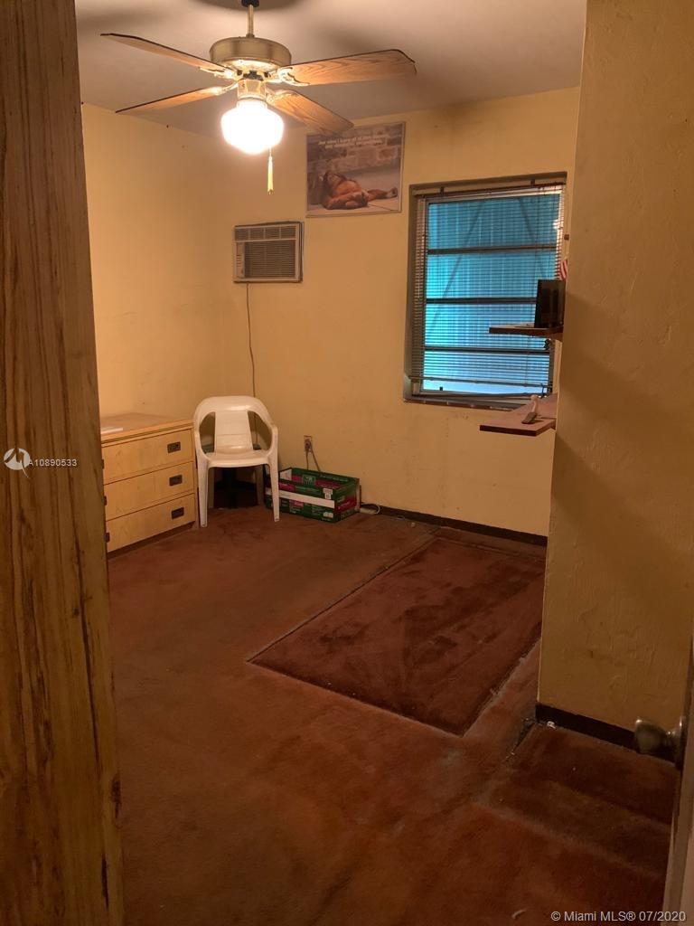 701 Tamiami Canal Road Miami, FL 33144 - Photo 5 of 13 a workspace with furniture and chandelier