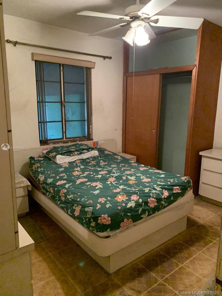 701 Tamiami Canal Road Miami, FL 33144 - Photo 6 of 13 a bedroom with a bed and a window