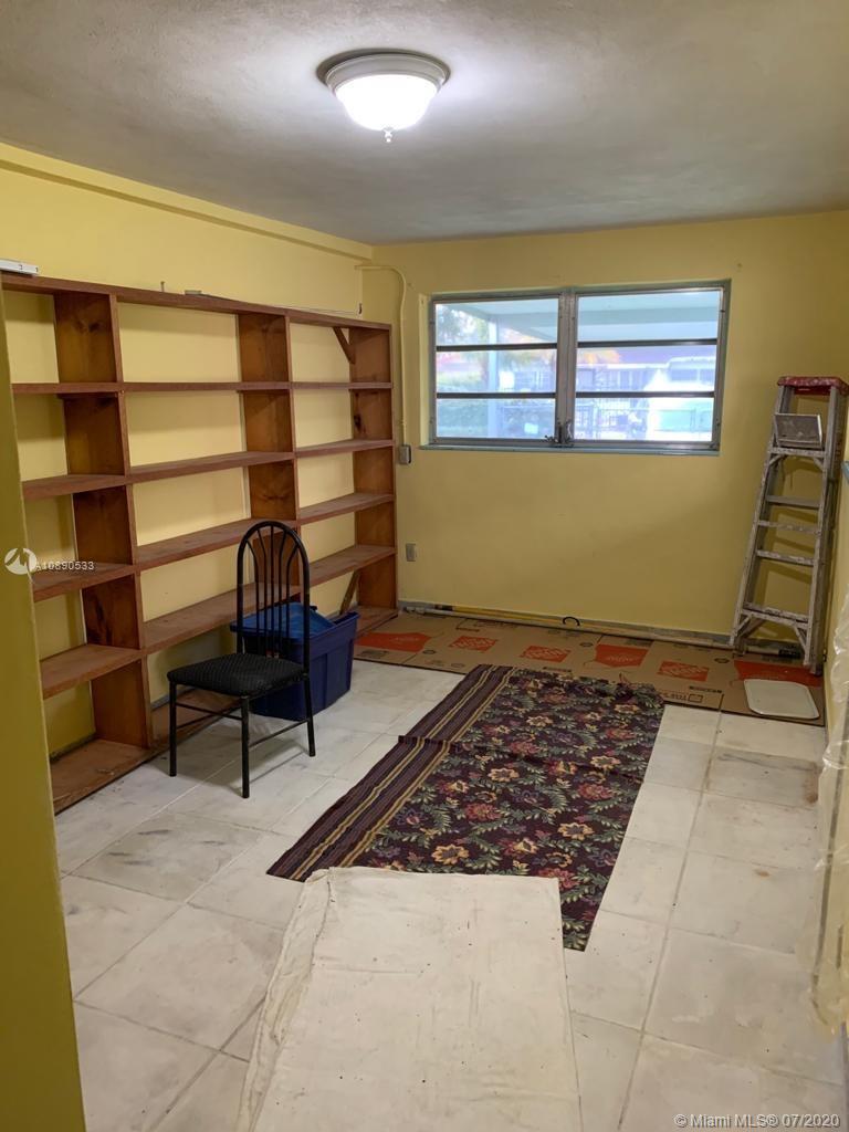 701 Tamiami Canal Road Miami, FL 33144 - Photo 8 of 13 a living room with a couch and a window