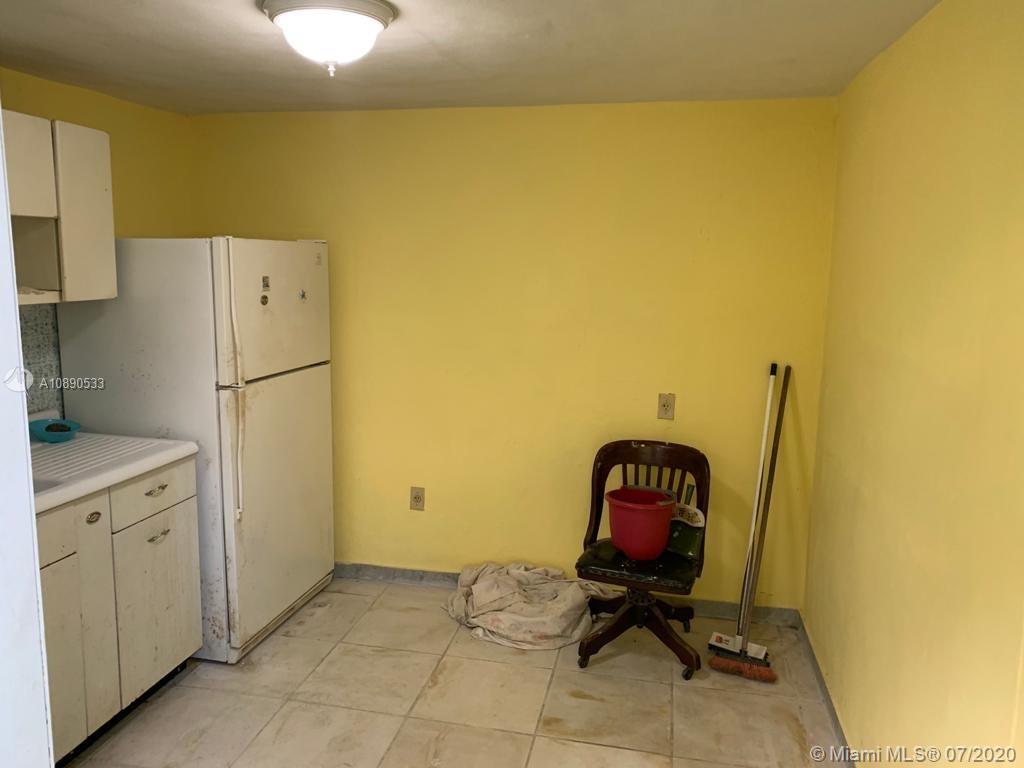 701 Tamiami Canal Road Miami, FL 33144 - Photo 9 of 13 a view of a livingroom with furniture and a refrigerator