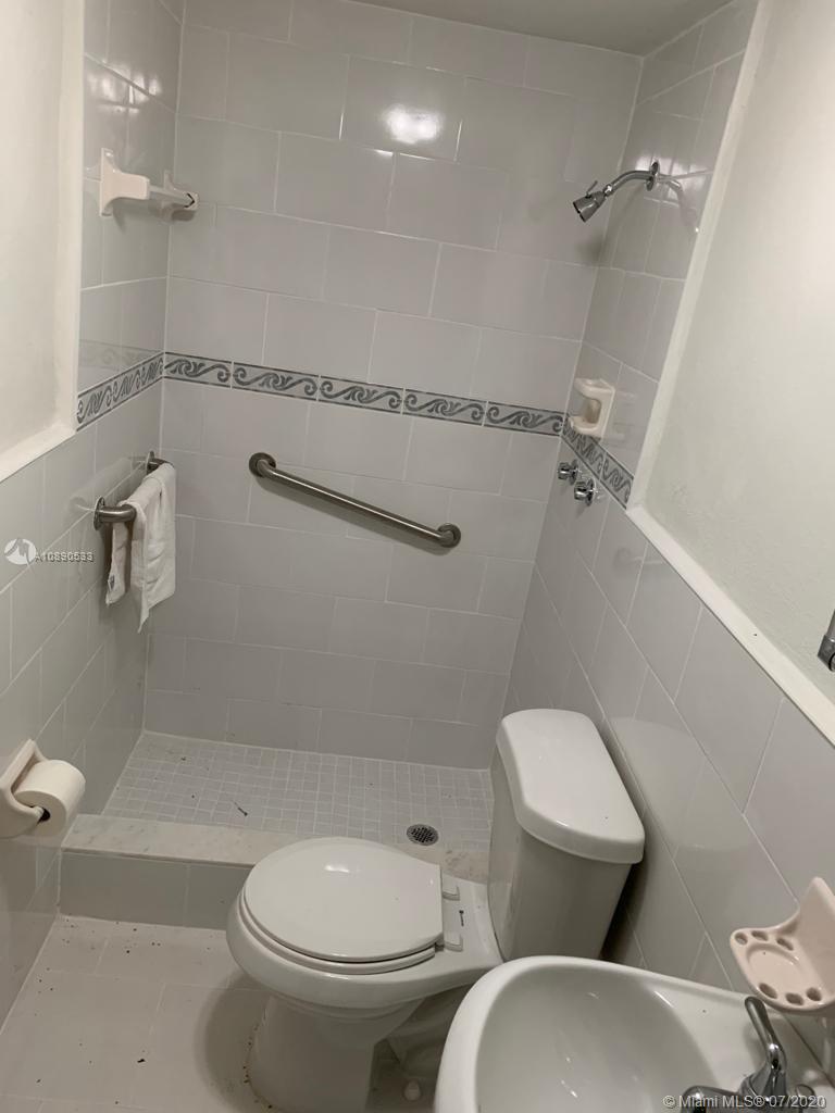 701 Tamiami Canal Road Miami, FL 33144 - Photo 10 of 13 a white toilet sitting next to a bath tub