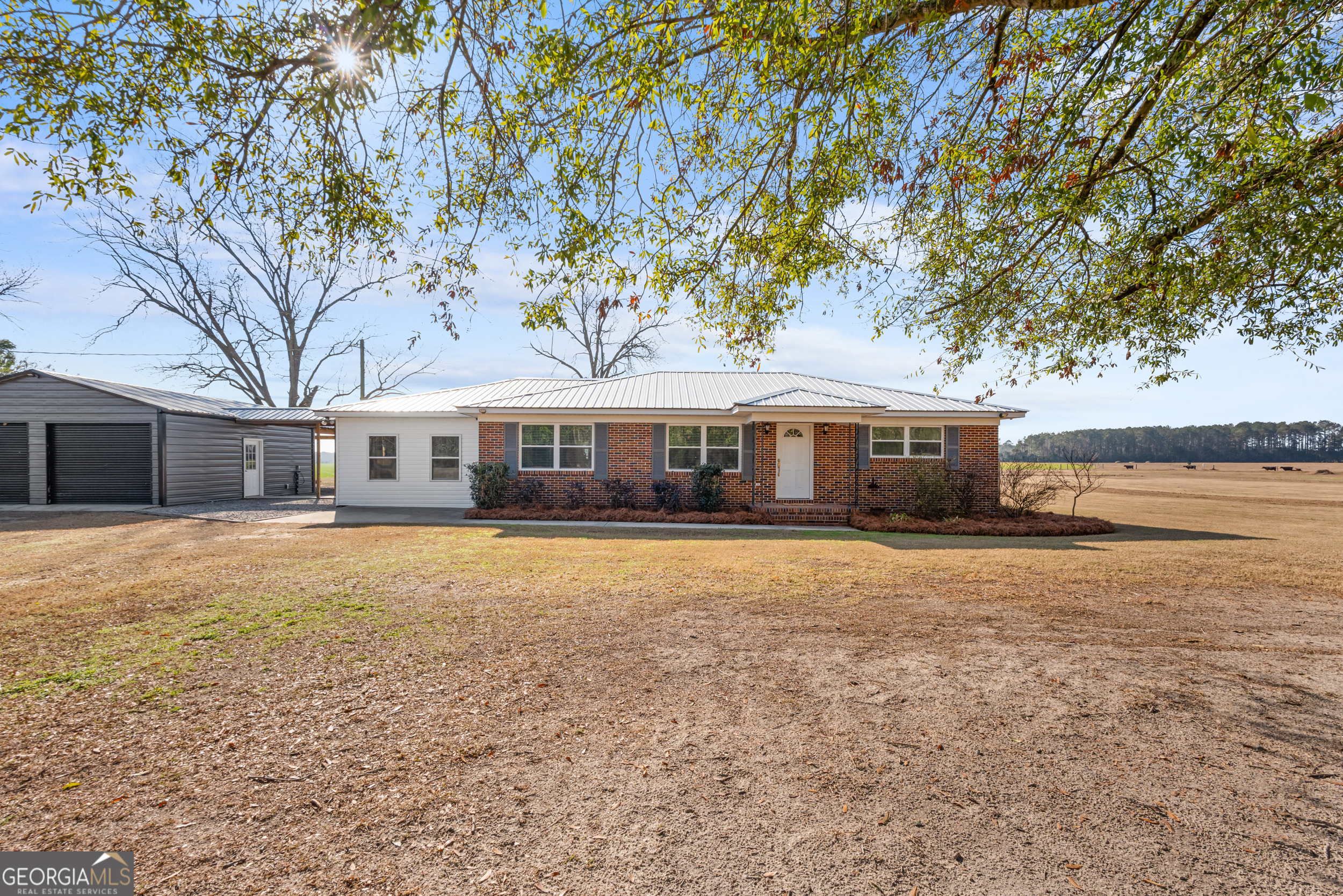 664 Boyd School Road Sylvania, GA 30467 - Photo 1 of 33 a front view of a house with a garden