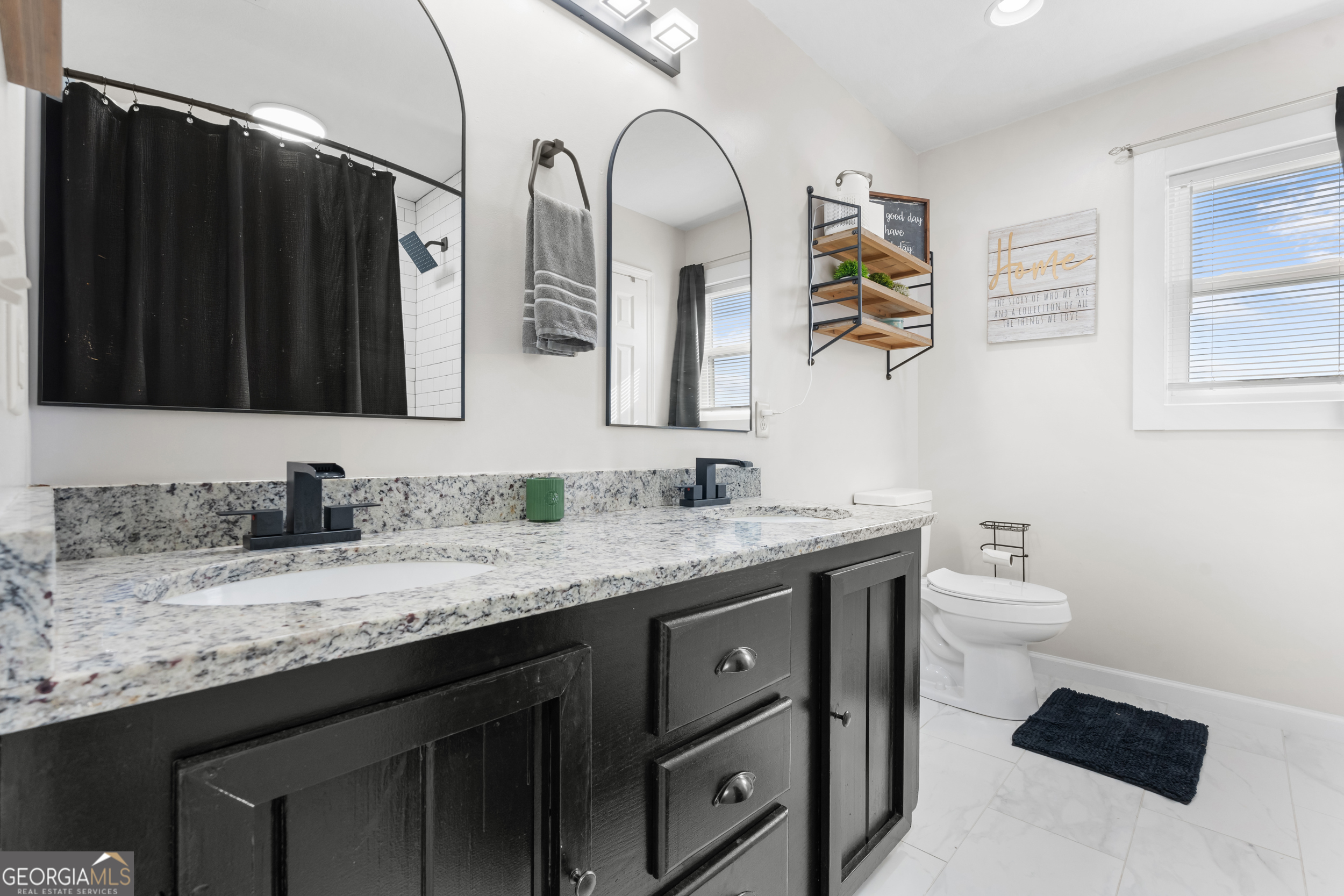 664 Boyd School Road Sylvania, GA 30467 - Photo 15 of 33 a bathroom with a granite countertop sink a toilet and mirror