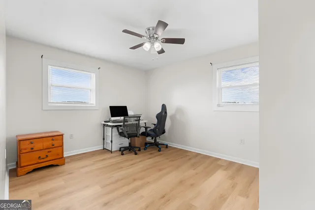 a view of a workspace with furniture and a window