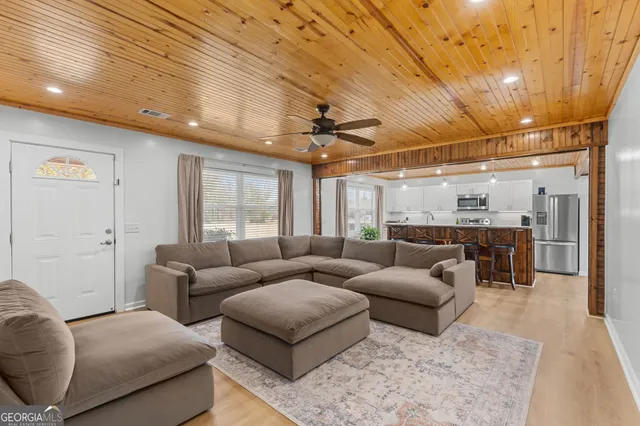 a living room with furniture and a chandelier