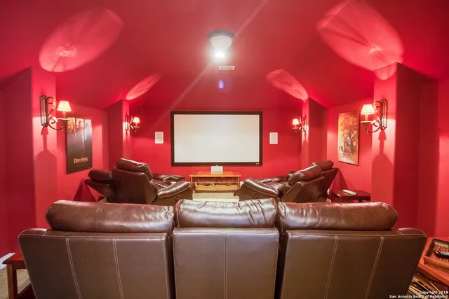 a room with furniture and a projector screen