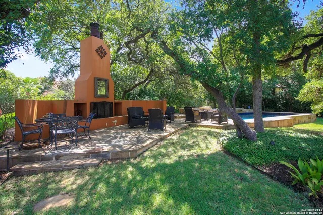a front view of a house with garden and sitting area