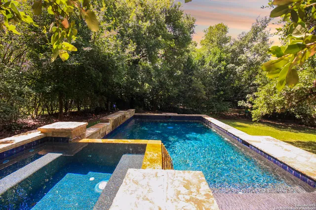 a view of a swimming pool with an outdoor space and seating area
