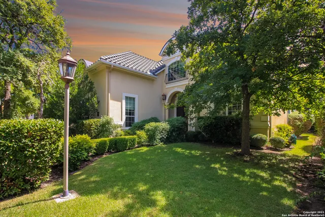 a view of a house with a yard and tree s