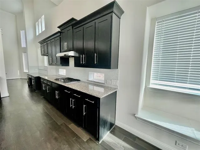 a kitchen with stainless steel appliances a sink stove and cabinets