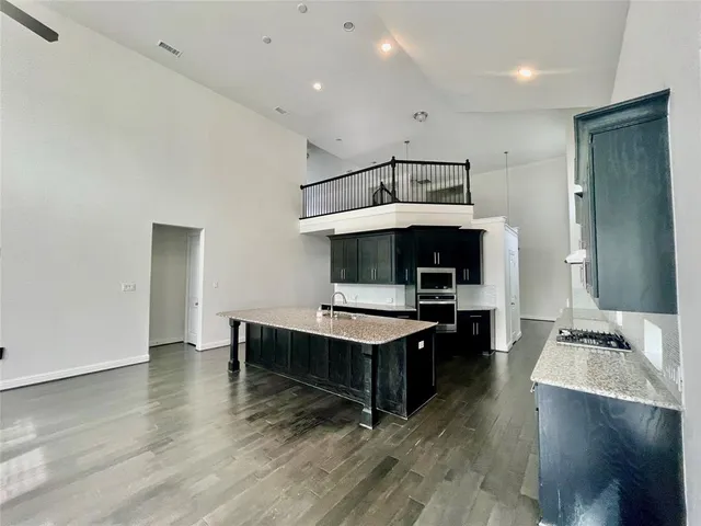 a living room with furniture flat screen tv and a wooden floor