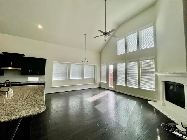 a view of a kitchen with a stove wooden floor and a kitchen