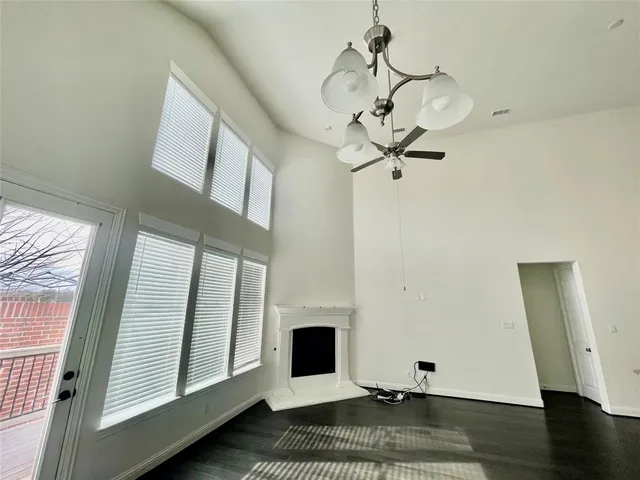 a view of a livingroom with wooden floor and a chandelier