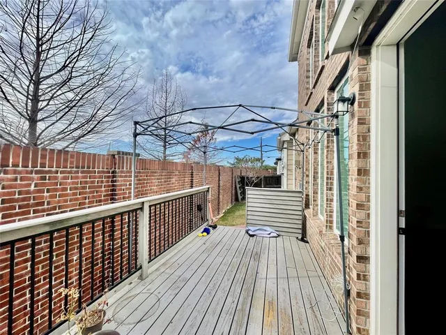 a view of balcony with wooden floor and fence