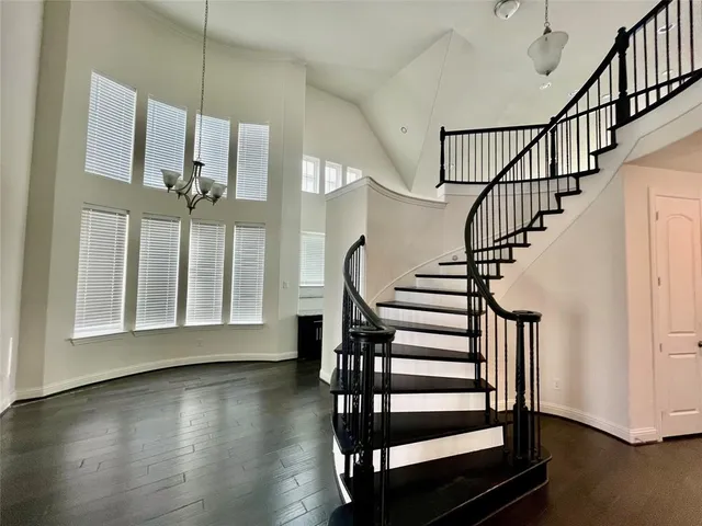 a view of entryway with wooden floor and stairs