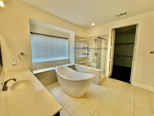 a bathroom with a bathtub and a shower