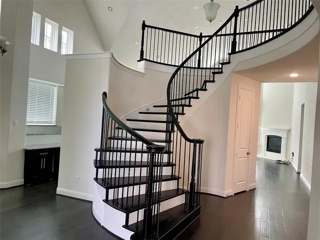 a view of entryway with wooden floor and a front door