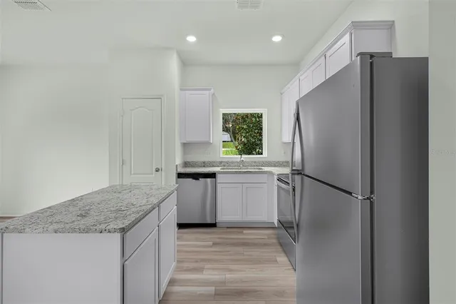a kitchen with a refrigerator and a sink