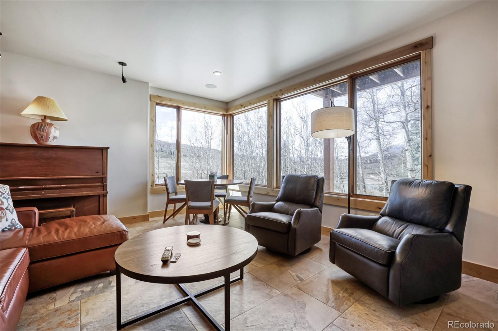 836 Maryland Creek Road Silverthorne, CO 80498 - Photo 16 of 49 a living room with furniture and a floor to ceiling window