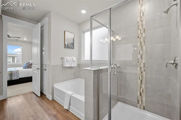 a bathroom with a tub shower and sink