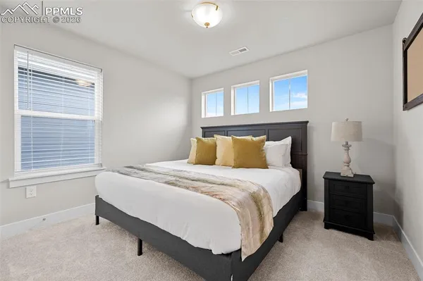 a bedroom with a bed and window