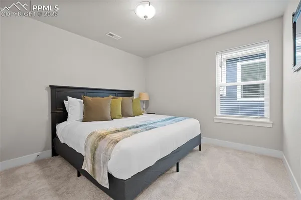 a bedroom with a bed and window