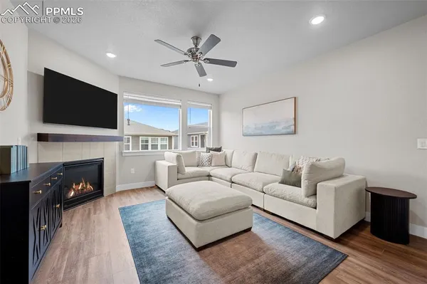 a living room with furniture a fireplace and a flat screen tv