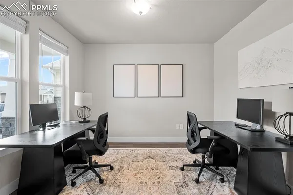 a view of a workspace with a window and chair