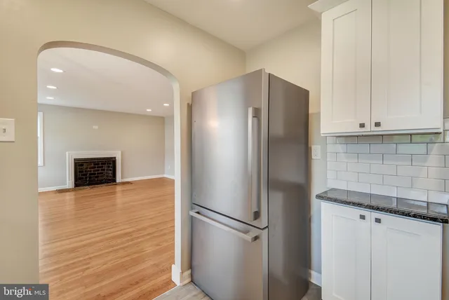 a metallic refrigerator freezer sitting in a kitchen