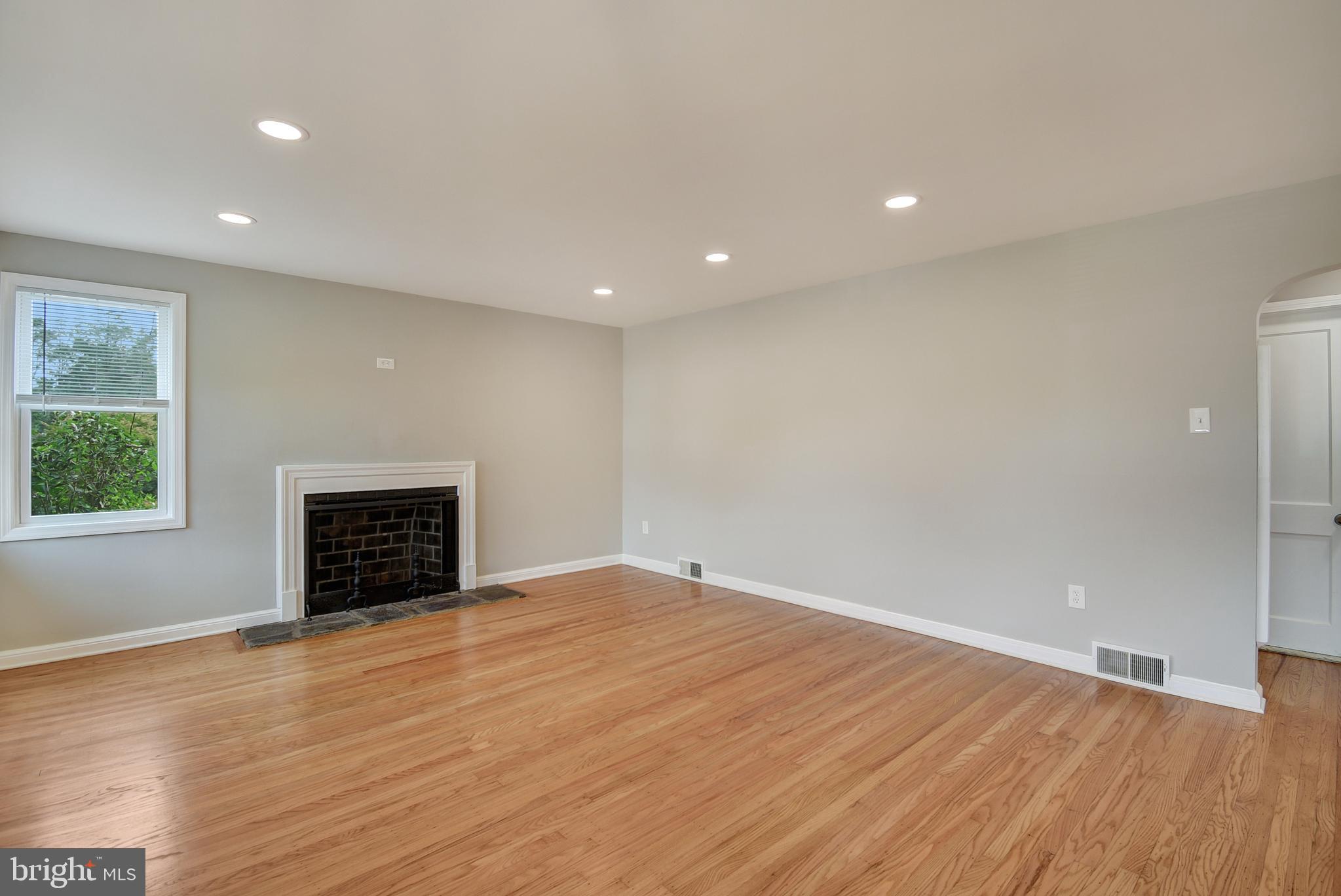 115 Locust Street Newtown Square, PA 19073 - Photo 5 of 17 an empty room with windows and fireplace