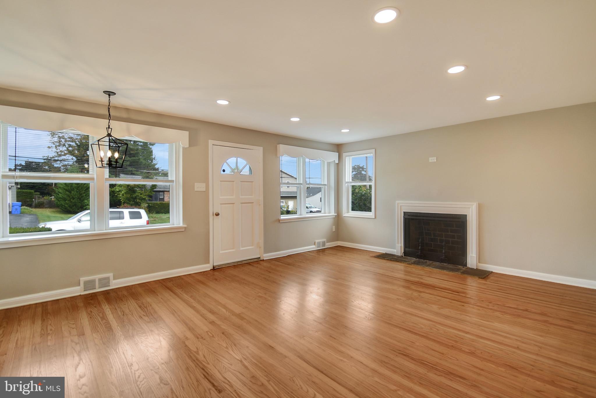 115 Locust Street Newtown Square, PA 19073 - Photo 6 of 17 a view of an empty room with wooden floor and a window