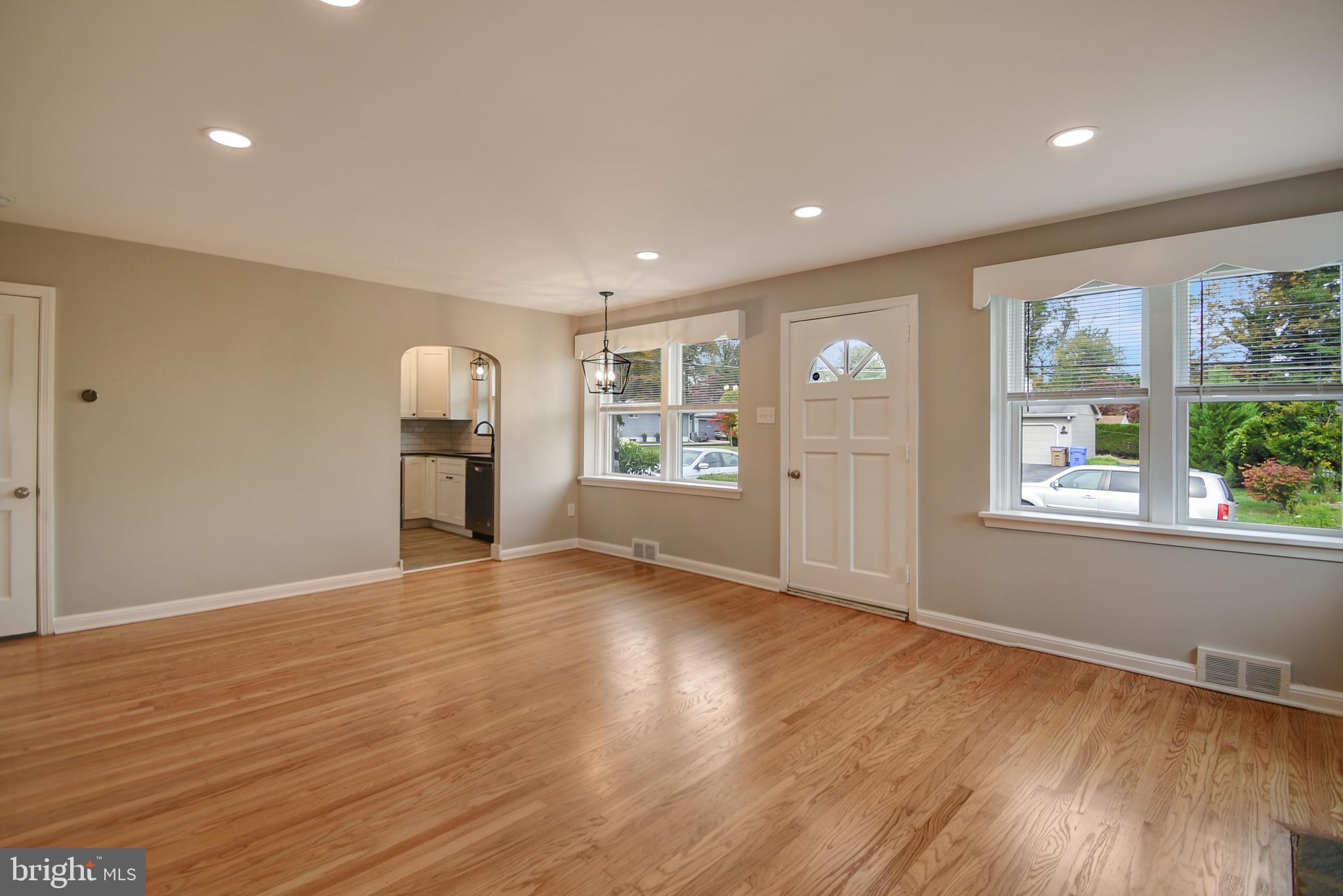 115 Locust Street Newtown Square, PA 19073 - Photo 7 of 17 a view of an empty room with a window and wooden floor