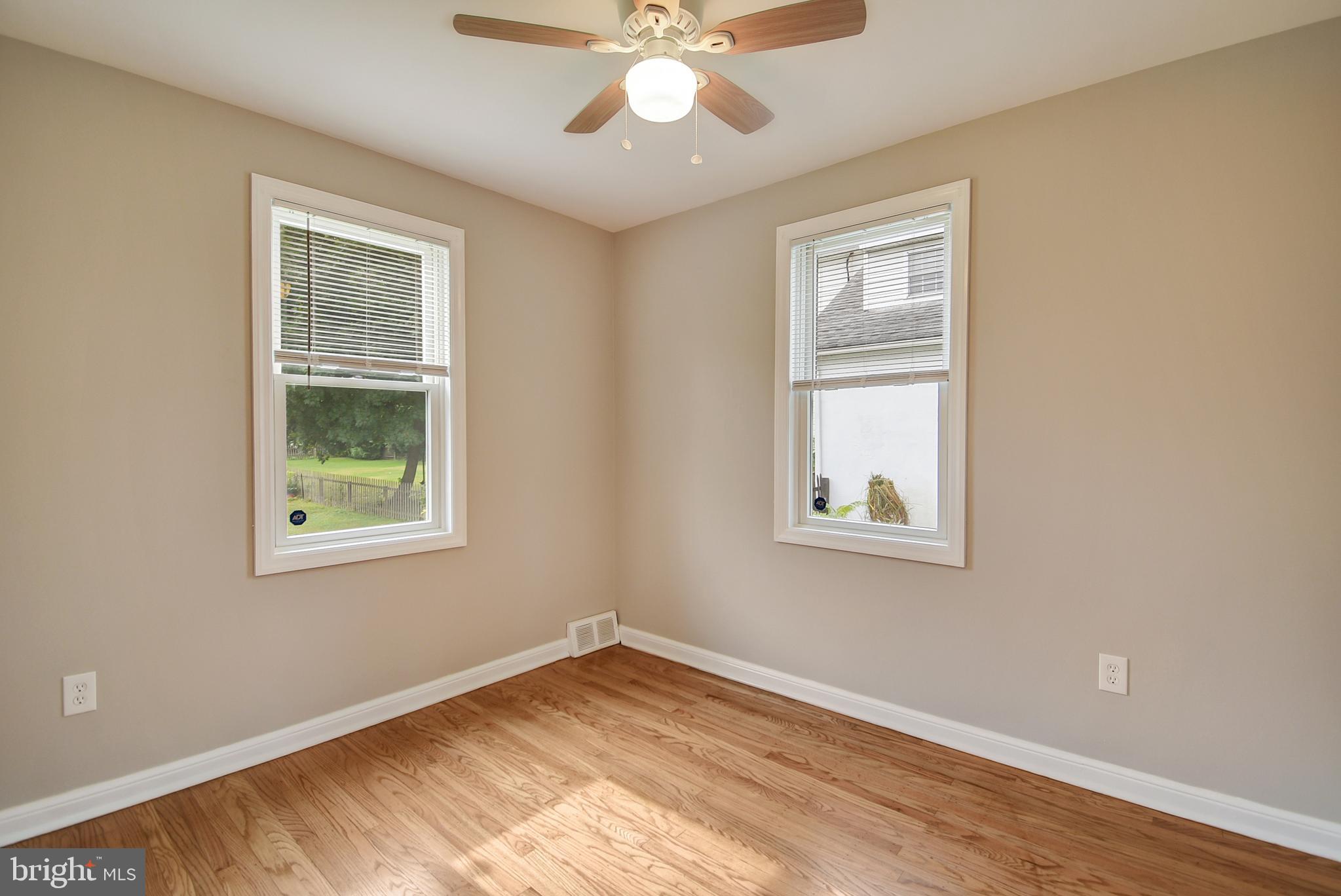 115 Locust Street Newtown Square, PA 19073 - Photo 10 of 17 a view of an empty room with wooden floor and a window