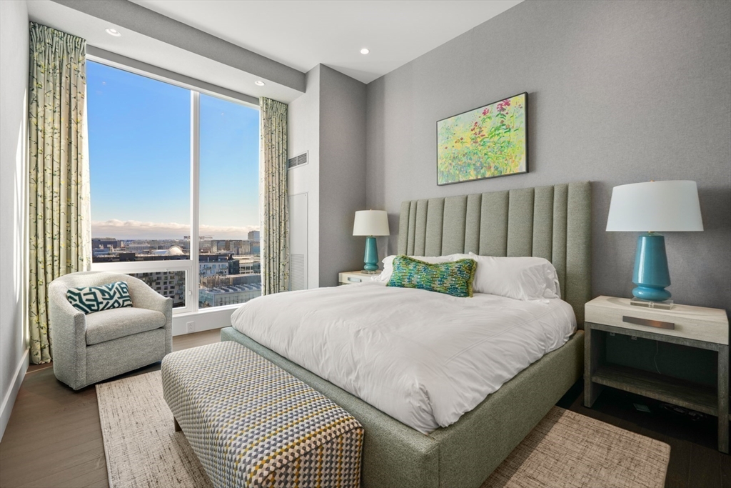 50 Liberty Drive, Unit PH1B Boston, MA 02210 - Photo 27 of 32 a bedroom with a bed couch and a large window