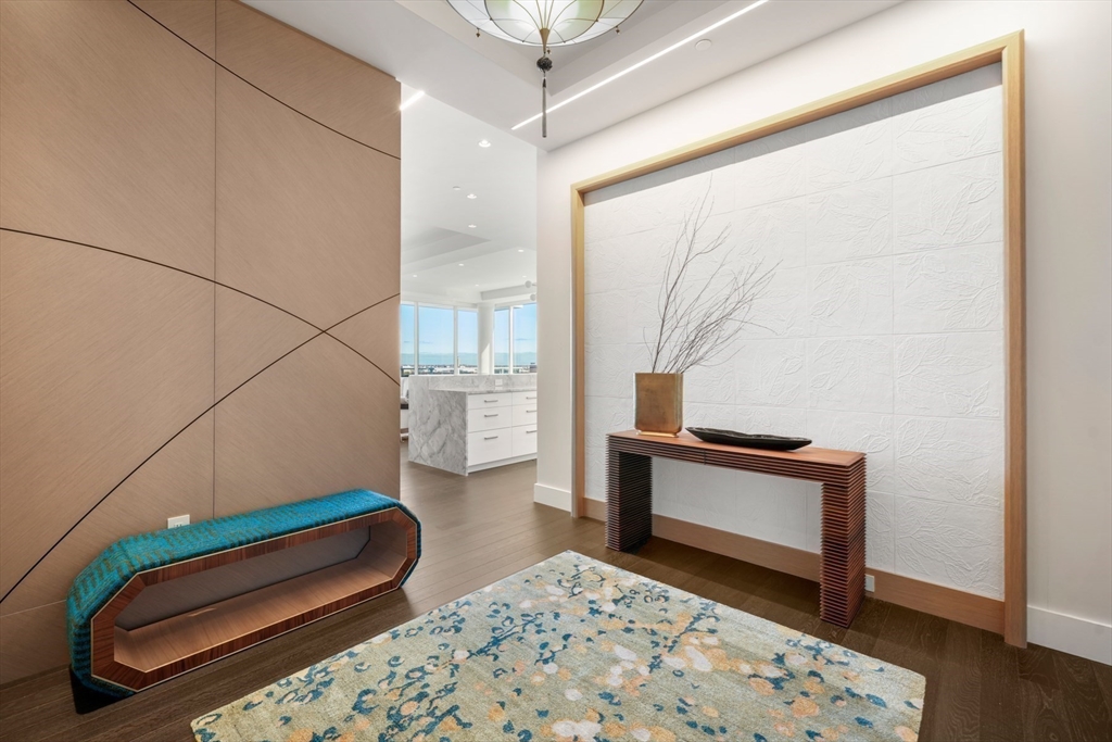 50 Liberty Drive, Unit PH1B Boston, MA 02210 - Photo 30 of 32 a bedroom with a bed and wooden floor