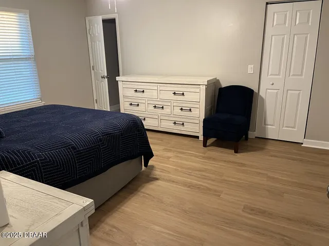 a bedroom with a bed and a dresser