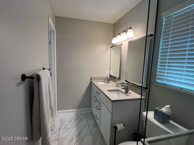 a bathroom with sink toilet and mirror