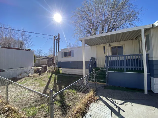 a view of a house with a wooden deck