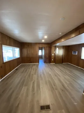 a view of wooden floor and windows in a room